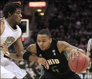 ASSOCIATED PRESSOhio's D.J. Cooper (5) drives past Akron defender Quincy Diggs in the first half. The Bobcats held off the Zips' late charge to win the Mid-American Conference men's championship.