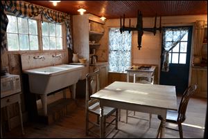 In the kitchen of the Decker House, appliances are concealed behind wainscoting, and cupboards and cabinets are on hinges. 