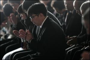 People mourn the victims of the March 11, 2011 earthquake and tsunami, at Jyodoji temple in Rikuzentakata, Iwate prefecture, northeastern Japan, Sunday.