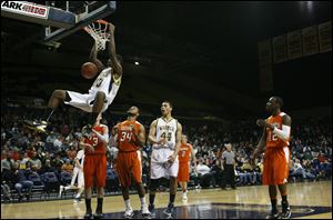 Whitmer High School player Nigel Hayes dunks against the Sylvania Southview defense in the second quarter during their Division I District final at Savage Arena on Saturday.