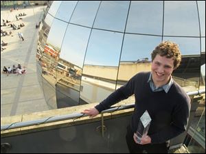 The Cambridge University student who is named UK Cyber Security Champion Jonathan Millican, poses for a photograph with his trophy at the Science Museum in Bristol, England, Sunday.  Millican is named UK Cyber Security Champion after beating off other contestants in the Cyber Security Challenge to seek out viruses and malware, raise firewalls and fend off hack attacks, in a competition aimed at pulling new talent into Britain's burgeoning cybersecurity sector.  