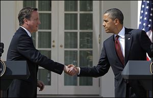 British Prime Minister David Cameron and President Barack Obama shake hands Wednesday during their joint news conference in the Rose Garden of the White House.