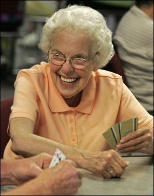 Rosemary Kehner, of Randolph, Ohio, enjoys the company and conversation as she and a group of senior citizens play euchre at the Lake Adult Community Center in Uniontown, Ohio, in this June, 2011, file photo.