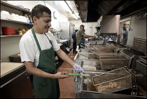 Employee David Lopez works on filling a customers order at George's restaurant in Waco, Texas.