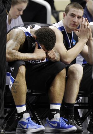 UNC-Asheville's J.P. Primm, left, and teammate Matt Dickey sit on the bench in the final seconds of a 72-65 loss to Syracuse.