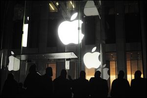 People gather Friday morning outside an Apple retail store on Fifth Avenue in the Manhattan borough of New York as they wait for the 8 a.m. local time release of the new iPad tablet. 