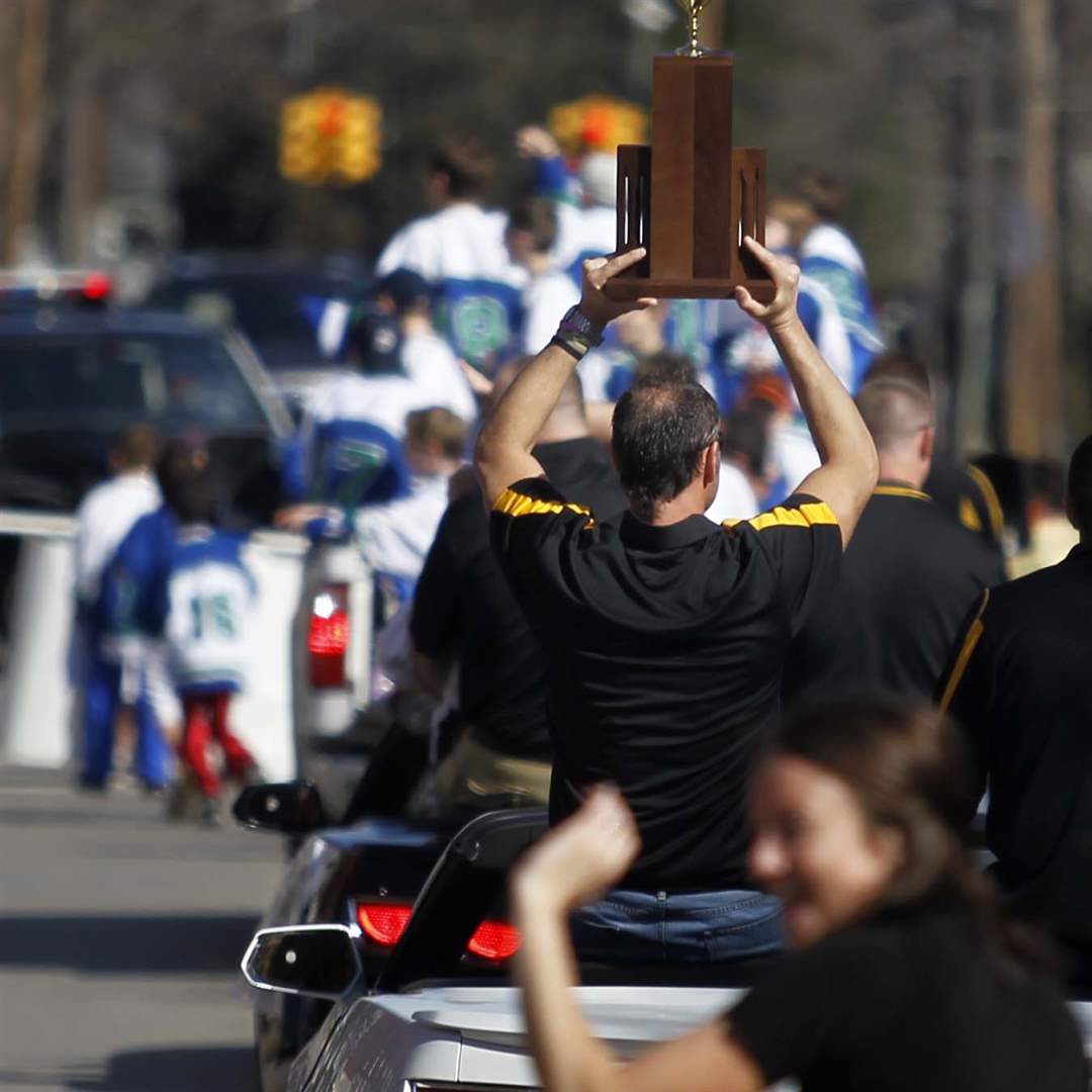 Northview-offensive-coach-Doug-Carter-holds-the-trophy