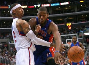 The Pistons' Greg Monroe, right, and the Clippers' Kenyon Martin battle for a loose ball.