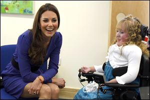 Britain's Duchess of Cambridge meets Bethany Woods in a music class during a visit to The Treehouse in Ipswich, England, Monday.