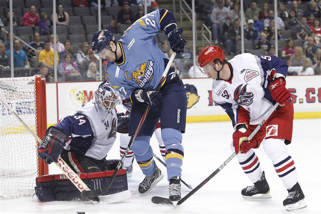 Toledo-Walleye-player-Riley-Emmerson-27-tries-to-get-the-puck-past-Elmira-goalie-Brian-Stewart