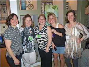 Members of the Mothers Center of Greater Toledo at the group's annual Whine and Cheese fund-raiser include, from left, Julie Winder, Brandy Davis, Tatum Buckholtz, Jackie Sheckler-Ramsdell, and Chandra Bryda.