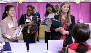 Martina Ryberg, right, of Plymouth State University, talks with Tara Rossetti of On Call International during a job fair for college students in Manchester, N.H.