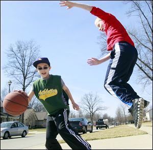 Sam Newcombe, right, and Cody Norton enjoyed the unusually warm weather in Temperance in March. The month set temperature records nationwide.