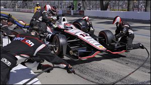 Will Power’s crew works to get him back on the track during a pit stop. Power is the points leader after the win.

