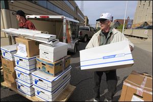 David Stone loads a trailer today after the FBI returned his possessions, that were seized in March, 2010, outside the federal building in Detroit. Much of the returned gear is military-style vests and other accessories worn by members of the Hutaree militia when they trained in the woods of southern Michigan. 