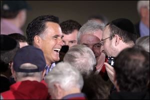 Mitt Romney greets supporters at a campaign rally at the factory in Lorain. He said the success President Obama vowed hasn't materialized.