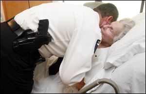 Police Lt. Mark King gives Evelyn Feiger a grateful hug for her volunteerism to the city of Toledo.