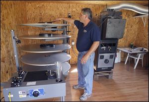 Rod Saunders prepares to check the projector at his Field of Dreams Drive-In Theater in Liberty Center, Ohio. A looming expense will happen soon as studios abandon film in favor of digital projection and films that are basically computer files. 