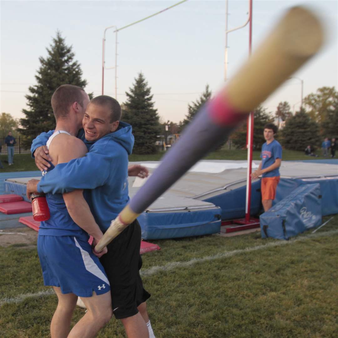 Pole-vaulter-Cody-Swisher-is-hugged-by-teammate-Devin-Dennard