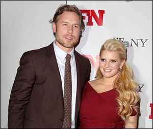 Singer Jessica Simpson, right, poses with her fiance Eric Johnson at the 25th Annual Footwear News Achievement Awards in November. The couple welcomed their baby girl into the world today.