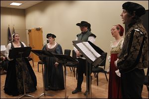 From left: Natalie Emptage, Lauren and Christopher Krieger, Heather Hamilton and Gyuri Barabas sing during An Evening with Shakespeare at the Bedford Branch Library in Temperance, Mich.