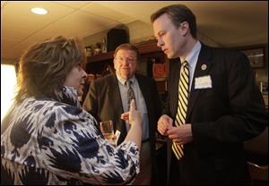 Cuyahoa County's top elected official, Ed FitzGerald, left, speaks to Lucas County Commissioner Carol Contrada, left and county administrator Peter Ujvagi at a Democratic Party fund-raiser at the home of Lucas County Clerk of Courts Bernie Quilter.