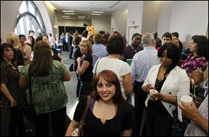 Maumee resident Alison Clark, front center, who will be a dealer at Hollywood Casino Toledo, mingles at a 