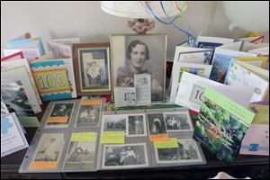 Birthday cards and photographs of Mrs. Cooper from decades past were set up for the birthday celebration.