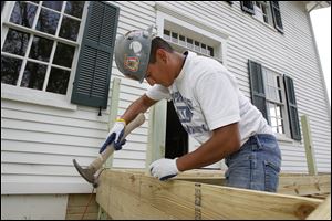 Aureliano Adame, Jr., builds a porch on the Lathrop House, which is linked to the Underground Railroad.