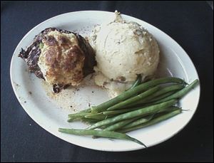 Rockwell’s Surf and Turf includes a 7-ounce prime grade top sirloin served with a crab cake, mashed potatoes, and green beans.