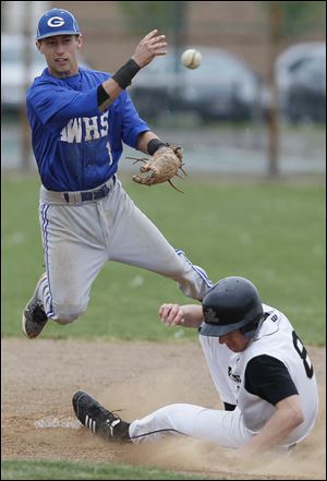 Anthony Wayne senior shortstop Deion Tansel turns a double play over Perrysburg's Gus Dimmerling. Tansel, who has signed to play at the University of Toledo, is hitting .403 and leads the NLL with 28 stolen bases.