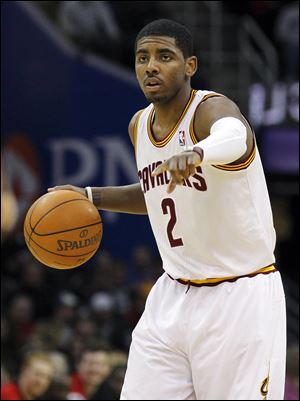 Cleveland Cavaliers guard Kyrie Irving directs the offense against the Chicago Bulls in an NBA basketball game in Cleveland.