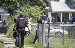 A Toledo Police SWAT team enters the home at 1018 Bricker Ave., where they found Junior Francous, 39, dead. An autopsy is today.