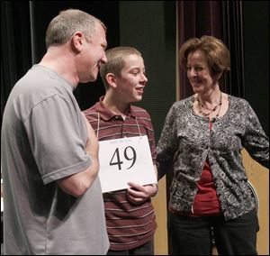 Spencer Hipsher, 13, a student at St. Wendelin in Fostoria, with his parents, Ron and Lynn Hipsher, is shown after winning the  Northwest Ohio Spelling Bee. He was eliminated from the national competition after three rounds on Wednesday. 