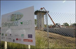 A sign board describes the building going up replacing the public housing in Toledo's central city area, now known as Collingwood Green. The area at Belmont Avenue and Division Street had been the site of Albertus Brown Homes and Brand Whitlock Homes.