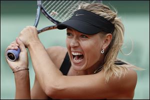 Maria Sharapova of Russia returns in the women's final match against Sara Errani of Italy at the French Open tennis tournament in Roland Garros stadium in Paris.