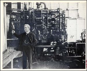 Michael Owens inspects a bottle just made by one of the earliest of his machines for making glass bottles automatically.