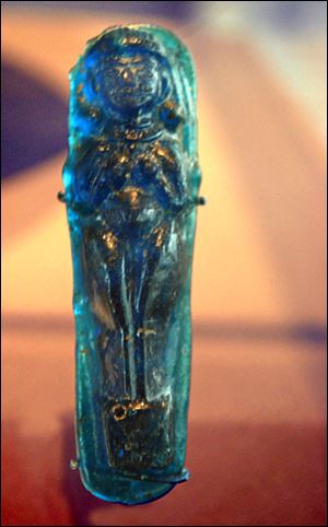 Made by pressing soft glass into a mold, this small pendant dates to 1500 BCE.