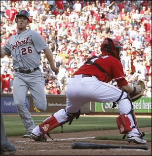 Detroit Tigers' Brennan Boesch (26) scores the go-ahead run at home plate ahead of Cincinnati Reds catcher Ryan Hanigan (29) after a single hit by Prince Fielder off Reds pitcher Sean Marshall in the eighth inning during a baseball game, Saturday.