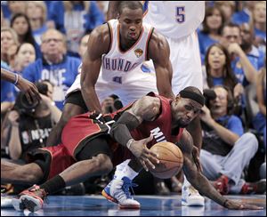 Oklahoma City's Russell Westbrook makes a pass around Miami's Udonis Haslem in Game 1 Tuesday night of the NBA Finals. Westbrook finished with 27 points, 11 assists and 8 rebounds.