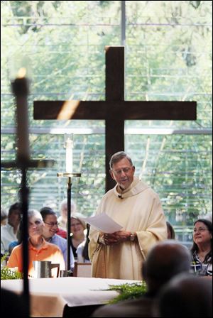 The Rev. Jim Bacik celebrates Mass at Corpus Christi University Parish. The 75-year-old priest is to say his final Masses there June 24. 