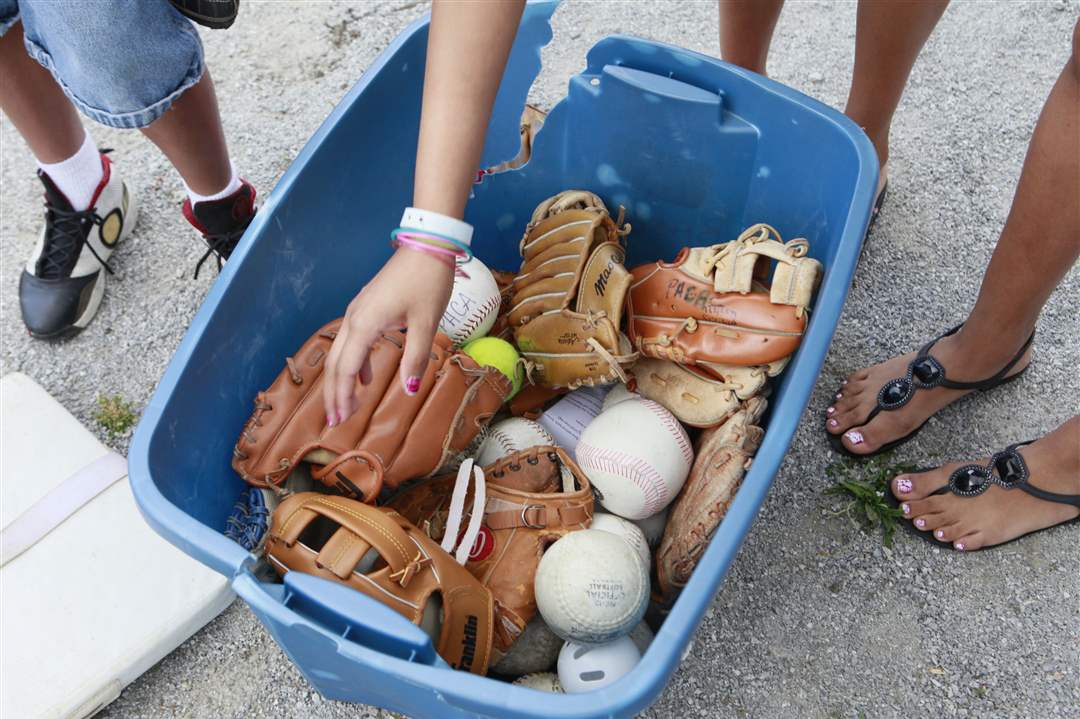 Kids-gather-their-gloves-and-balls