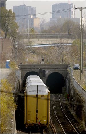 A train disappears from sight in Detroit, heading under the Detroit River on its way to Canada. 