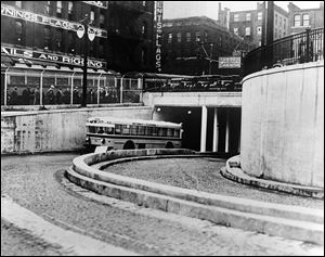 A bus emerges from the tunnel in Detroit in early December, 1930. Construction began in 1928. The tunnel, jointly owned by the cities of Detroit and Windsor, Ontario, is only one lane each way and cannot be widened.