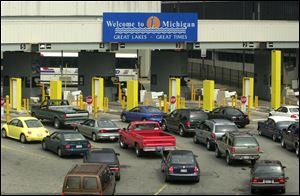 Cars line up at customs checkpoints in Detroit after traveling through the Detroit-Windsor Tunnel from Canada. Nearly 3.8 million vehicles used the the tunnel in 2011.