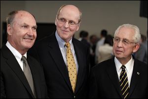 From left, Big Ten Commissioner Jim Delany, BCS executive director Bill Hancock and SEC Commissioner Mike Slive smile during an interview after a BCS presidential oversight committee meeting and media availability, Tuesday, in Washington.