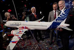 Alabama Gov. Robert Bentley, right, and Airbus President & CEO Fabrice Bregier celebrate the announcement that Airbus will establish its first assembly plant in the United States in Mobile, Ala.