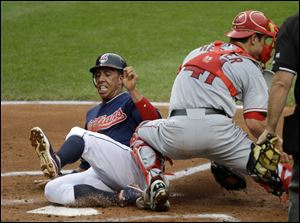 Cleveland Indians' Michael Brantley slides past Los Angeles Angels catcher John Hester to score on a sacrifice fly by Shelley Duncan in the second inning of a baseball game Tuesday.