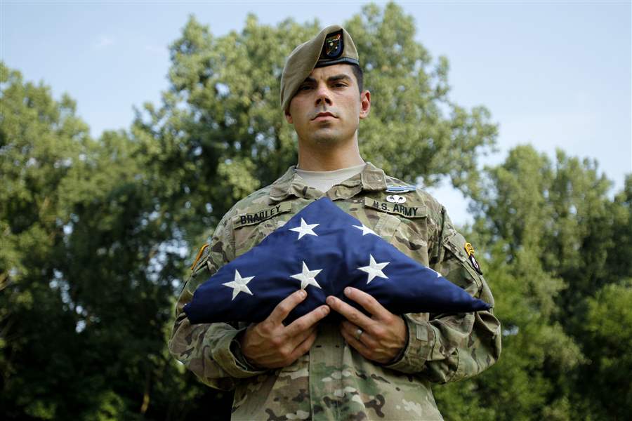 Ranger-Kyle-Bradley-holds-one-of-the-flags-he-carried-during-deployments