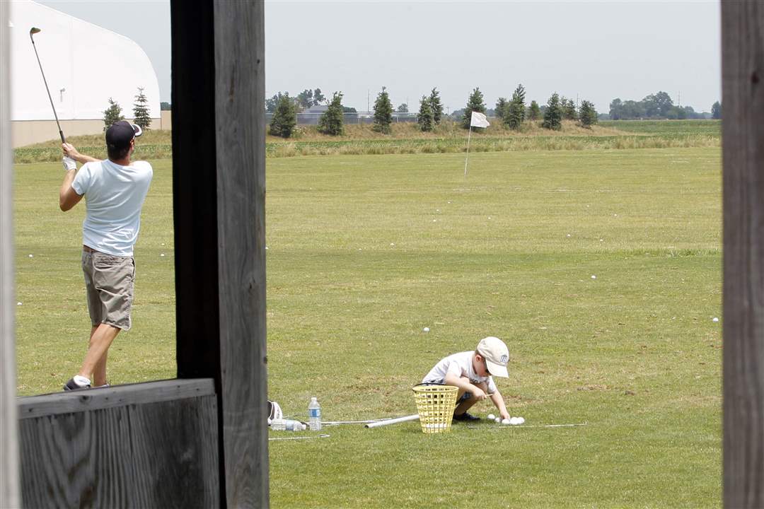 Gary-Valentine-left-4-picks-up-golf-balls-and-tees